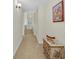 Hallway with tan carpet, neutral walls, and a decorative chest with flowers at 7912 Desoto Memorial Hwy, Bradenton, FL 34209