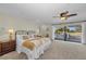 Bright main bedroom with a ceiling fan and sliding glass doors opening to the deck at 7912 Desoto Memorial Hwy, Bradenton, FL 34209