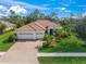 Beautiful home featuring a red tile roof, brick driveway, and lush landscaping at 8248 Larkspur Cir, Sarasota, FL 34241