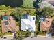 Aerial shot showcases a beautiful pool home with manicured lawn in a desirable neighborhood at 8579 Woodbriar Dr, Sarasota, FL 34238