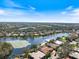 Wide aerial shot of neighborhood and lake with listing pinned at 8579 Woodbriar Dr, Sarasota, FL 34238