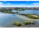 Aerial view of a scenic bridge and waterway surrounded by lush greenery and blue waters in Sarasota, Florida at 8579 Woodbriar Dr, Sarasota, FL 34238