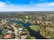 Aerial view of waterfront home in a desirable community, surrounded by lush landscaping at 8579 Woodbriar Dr, Sarasota, FL 34238