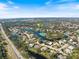 Wide aerial view of neighborhood and lake with pin on listing home at 8579 Woodbriar Dr, Sarasota, FL 34238