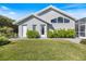 Well-kept backyard featuring manicured lawn, mature landscaping, and views of screened in lanai at 8579 Woodbriar Dr, Sarasota, FL 34238