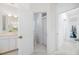 Bright bathroom features a sink vanity and linen closet with access to a toilet room and bedroom at 8579 Woodbriar Dr, Sarasota, FL 34238