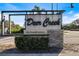 Deer Creek on Palmer Ranch community sign with stacked stone base and manicured landscaping in Sarasota, Florida at 8579 Woodbriar Dr, Sarasota, FL 34238
