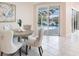 Cozy dining area with elegant chairs, view of the pool, and sliding glass doors at 8579 Woodbriar Dr, Sarasota, FL 34238