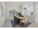 Light-filled dining room with a large window, stylish chandelier, and seating for six at 8579 Woodbriar Dr, Sarasota, FL 34238