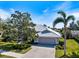 Beautiful single-story home with a well-maintained lawn and a wide driveway leading to a two-car garage at 8579 Woodbriar Dr, Sarasota, FL 34238
