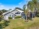 Backyard with a screened-in lanai, showcasing the property's well-maintained landscaping at 8579 Woodbriar Dr, Sarasota, FL 34238