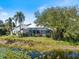 Charming single Gathering home boasts a large, screened in lanai and beautiful water views at 8579 Woodbriar Dr, Sarasota, FL 34238