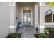 Inviting front porch with a bench and a blue double front door, creating a warm welcome at 8579 Woodbriar Dr, Sarasota, FL 34238