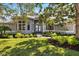 Charming home featuring a beautifully landscaped front yard and a welcoming entryway at 8579 Woodbriar Dr, Sarasota, FL 34238