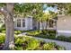 Lovely home with lush landscaping, a brick walkway, and a light blue front door at 8579 Woodbriar Dr, Sarasota, FL 34238