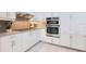 Modern kitchen featuring sleek stainless steel appliances, updated countertops, and ample cabinet space at 8579 Woodbriar Dr, Sarasota, FL 34238