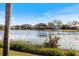 Picturesque lake view showcasing the calm water and distant homes at 8579 Woodbriar Dr, Sarasota, FL 34238
