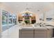 Spacious living room with high ceilings, built-in shelving, and view of the pool at 8579 Woodbriar Dr, Sarasota, FL 34238