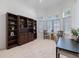 Bright office features built-in bookshelves and a large window, perfect for working from home at 8579 Woodbriar Dr, Sarasota, FL 34238