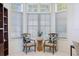 Bright office nook with two chairs and a small table, perfect for reading or relaxing at 8579 Woodbriar Dr, Sarasota, FL 34238
