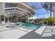 Screened pool and spa offer relaxation with a scenic backyard lake view at 8579 Woodbriar Dr, Sarasota, FL 34238
