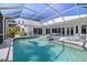 A beautiful screened pool and spa surrounded by ample lounge seating at 8579 Woodbriar Dr, Sarasota, FL 34238