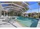 Screened pool and spa offer relaxation with a scenic backyard lake view at 8579 Woodbriar Dr, Sarasota, FL 34238