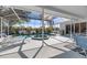 A screened-in pool and hot tub offer outdoor relaxation with a lovely lake view at 8579 Woodbriar Dr, Sarasota, FL 34238