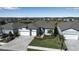 Aerial view of homes with landscaped yards, paver driveways and two car garages at 8714 Backshore Ln, Parrish, FL 34219