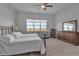 Bedroom with a ceiling fan, carpeted floor, and a large window overlooking the outside scenery at 8714 Backshore Ln, Parrish, FL 34219