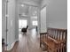 Inviting hallway with wood floors, bench seating and a view into the spacious living areas at 8714 Backshore Ln, Parrish, FL 34219