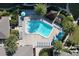 Aerial view of the pool area showcasing ample lounge chairs, lush landscaping and a tranquil place to relax at 1200 E Peppertree Ln # 305, Sarasota, FL 34242