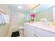 Bright bathroom featuring a shower-tub combination, white cabinets, and ample counter space at 1200 E Peppertree Ln # 305, Sarasota, FL 34242