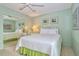 Cozy bedroom with a mirrored closet, a cushioned bed, and neutral-colored walls at 1200 E Peppertree Ln # 305, Sarasota, FL 34242