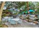 Outdoor dining area with grills, tables, and chairs, ideal for enjoying meals with friends and Gathering at 1200 E Peppertree Ln # 305, Sarasota, FL 34242