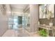 Inviting foyer featuring decorative mirrors, a glass table with décor, tile floors, and stylish artwork at 1200 E Peppertree Ln # 305, Sarasota, FL 34242