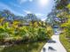 Waterfront property with lush tropical plants and a sidewalk leading to the dock at 1240 Northport Dr, Sarasota, FL 34242