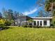 Green backyard with a screened in porch at 1240 Northport Dr, Sarasota, FL 34242