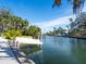 Private boat dock with lift system along a waterfront property with clear blue skies at 1240 Northport Dr, Sarasota, FL 34242