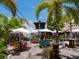 Enchanting outdoor dining area with lush palms and colorful seating in a tropical setting at 1240 Northport Dr, Sarasota, FL 34242