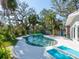 Backyard pool area with lounge chairs and lush landscaping, ideal for relaxation at 1240 Northport Dr, Sarasota, FL 34242