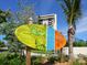 Colorful Siesta Key Village sign with lush landscaping in front of the high rise building at 1240 Northport Dr, Sarasota, FL 34242