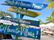 Colorful signs directing visitors to the Siesta Key Farmer's Market for fresh produce and seafood at 1240 Northport Dr, Sarasota, FL 34242