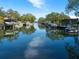 Scenic waterfront view with boats docked along a serene canal and lush greenery in a peaceful neighborhood at 1240 Northport Dr, Sarasota, FL 34242