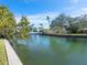 Wide canal view featuring boat docks and lush landscaping on a sunny day at 1240 Northport Dr, Sarasota, FL 34242