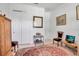 This bedroom features light wood flooring, white walls, and a red Persian style rug at 13303 Swiftwater Way, Lakewood Ranch, FL 34211