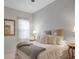 Comfortable bedroom featuring a plush bed with decorative pillows, side tables, and soft, natural lighting at 13303 Swiftwater Way, Lakewood Ranch, FL 34211