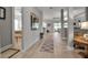 Inviting hallway featuring light wood floors and neutral paint tones, seamlessly connecting living spaces at 13303 Swiftwater Way, Lakewood Ranch, FL 34211