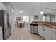 Bright kitchen featuring stainless appliances, granite countertops, and adjacent dining area at 13303 Swiftwater Way, Lakewood Ranch, FL 34211