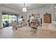 Bright living room with a view to the lanai, featuring neutral tones, wood floors, and comfortable seating at 13303 Swiftwater Way, Lakewood Ranch, FL 34211